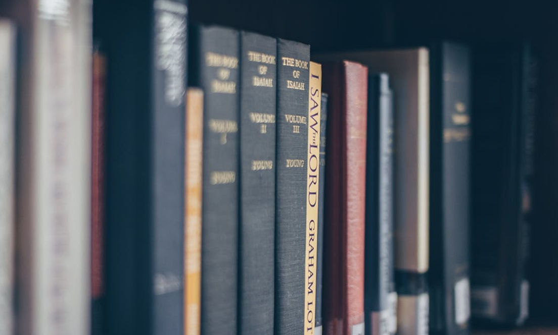 Books aligned on a library shelf